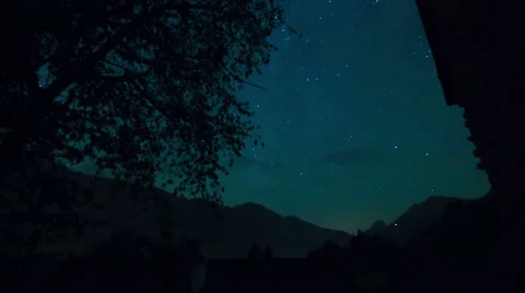 Night time lapse with mountain landscape and falling stars Stock Footage 53647650