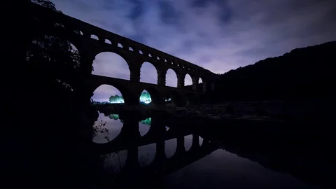 Night time lapse of an old roman bridge, pont du gard aqueduct Stock Footage 95947378