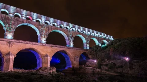 Night time lapse of an old roman bridge, pont du gard aqueduct Stock Footage 95947870