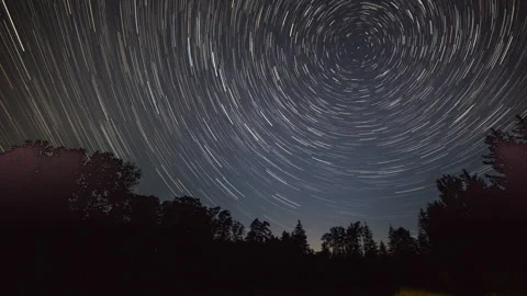 Night time lapse with star trails over forest. North Star surroundings. Stock Footage 244769346
