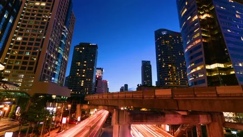 Night time lapse view of traffic and sky train on Bangkok, Thailand. Stock Footage 168181573