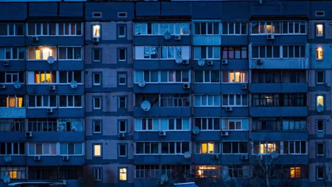 Night Time-lapse in the Windows of a Multi-story Building Stock Footage 261592137