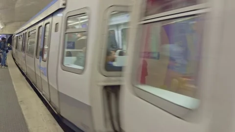Night-time shot of passengers and RATP Métro trains arriving on Line 8 platform Video stock 323914938