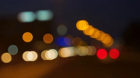 Night time soft focus bokeh shot of driving in town traffic Stock Footage 100572427