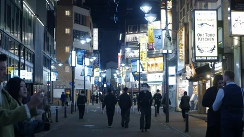 Night time street view of walking street shopping area in night time with c.. Video stock 340308367