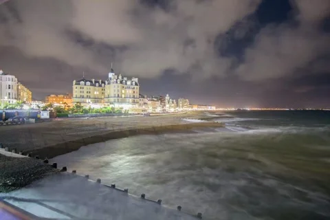 Night time timelapse of the Queens Hotel, Eastbourne Stock Footage 147734697