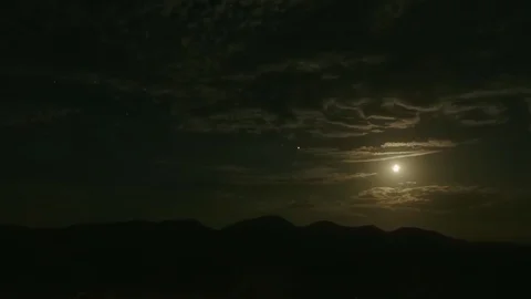 NIGHT TIME TIMELAPSE OF SKY WITH CLOUDS AND MOON Video stock 127473759