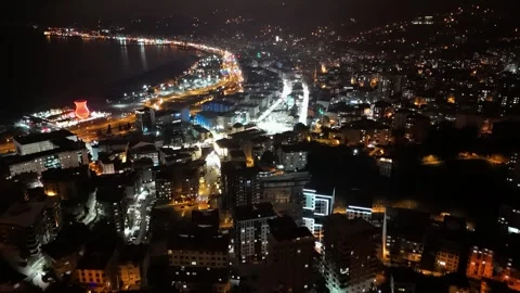 Night time view of a city with a river and a bridge Video stock 268947450