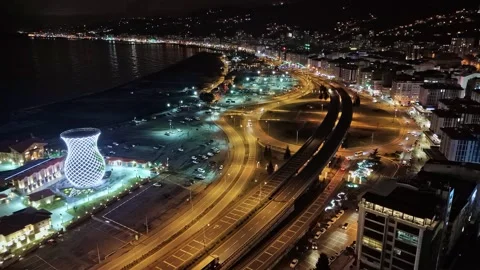 Night time view of a city with a train and a train track Stock Footage 268915705