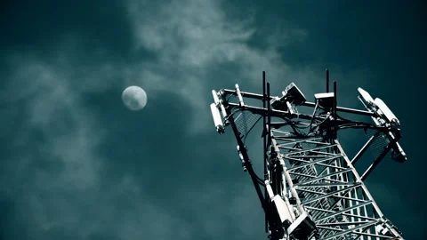 Night Timelapse. Clouds and full moon over 5G small cell radio antennas tower Stock Footage
