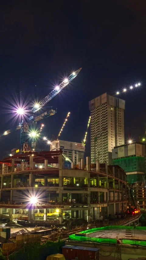 Night timelapse of construction site. Many cranes move, high-rise buildings in Stock Footage 272622458