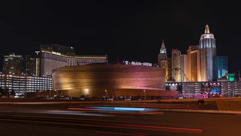 Night timelapse of Las Vegas Strip city skyline, casinos, sports arena, highway Stock Footage 121694792