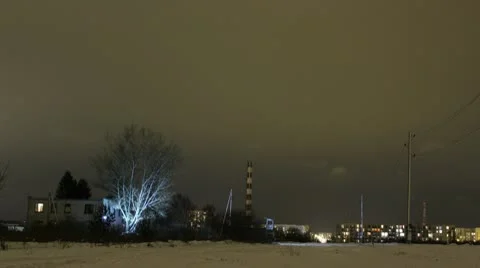NIght timelapse light on tree, clouds going by 4k Stock Footage 10768816