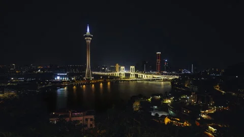 Night timelapse of Macao skyline with Macau Tower and Sai Van Bridge reflected Stock Footage 320613906