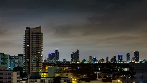 Night timelapse of Modern skyscraper condo building, cloudy sky, Miami Beach Stock Footage 100840505