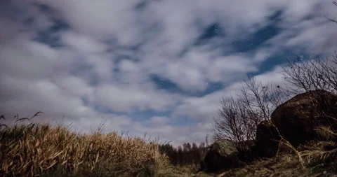 Night timelapse on moving clouds with starry sky. 4K Stock Footage 143734514