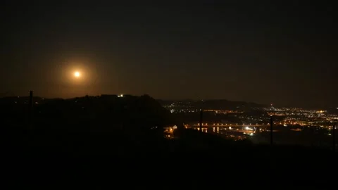 Night timelapse of moving fool moon above the hill and bridge Stock Footage 132299395