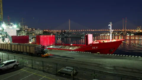 Night timelapse. Process of loading freight into the cargo ship with cranes Video stock 163521759