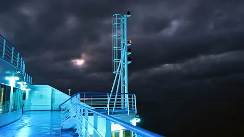Night timelapse of a ship deck under dark sky clouds Stock Footage 154179562