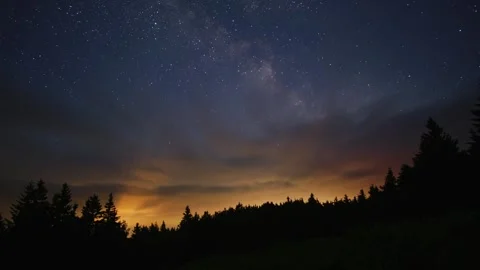 Night timelapse showing clouds clearing to reveal a starry sky and the Milky Way Stock-Footage 313870477