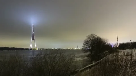Night timelapse of winter river and high tower 4k Stock Footage 10768797