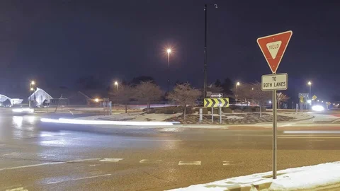 A Night Timelapse of a Yield Sign and Traffic Stock Footage 85574977