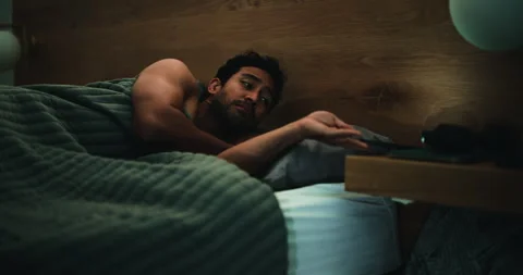 Night, tired man and scroll in bed with phone for social media, notification and Stock Footage 323266632