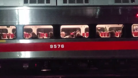 Night tracking shot of passenger train getting further from camera Stock Footage 121388264