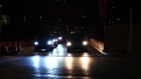 Night traffic coming at the camera &amp; making a l - r turn Stock Footage 140466094