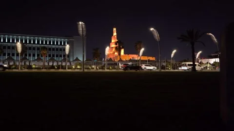 Night traffic on Doha Corniche with iconic illuminated streetlights Видео 342903763