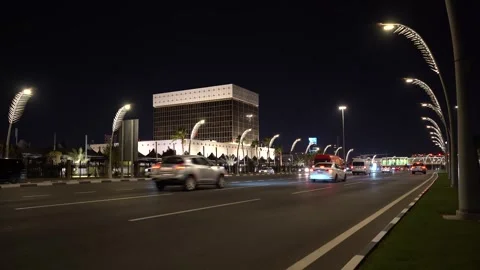 Night traffic on Doha Corniche with iconic illuminated streetlights Видео 342903766
