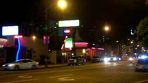 Night Traffic On Downtown Street With Restaurants Stock Footage