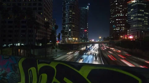 Night Traffic with Graffiti Wall in Foreground Vídeo Stock 79893164