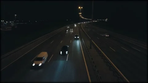Night traffic on the highway with lanterns view from the bridge oncoming cars go Stock Footage 159538553
