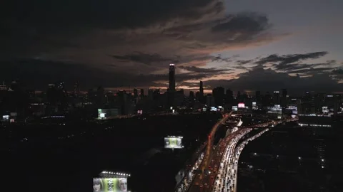 Night Traffic Jam and Sunset Over Modern City Skyline in Bangkok, Thailand Stock Footage 333599291