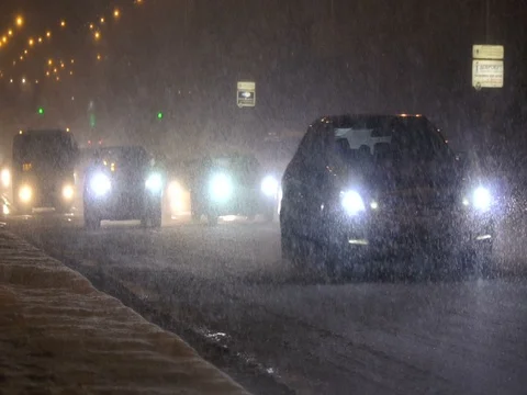 Night traffic moving in a snowfall. Winter storm. Stock Footage 83541425