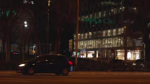 Night traffic passing modern office building Video stock 329592875