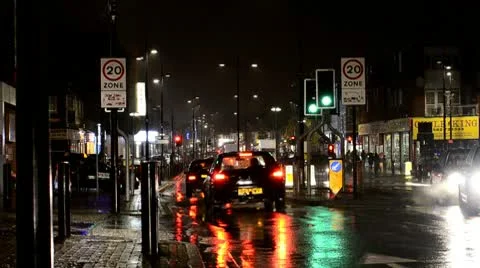 Night traffic in the rain Stock Footage 10565420