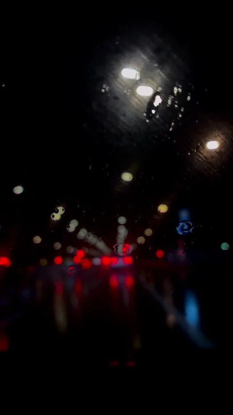 Night traffic in the rain Stock Footage 309753432
