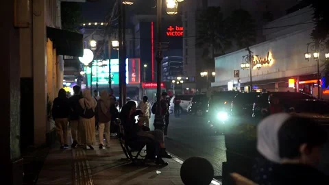 Night traffic scene on Jalan Braga, Bandung, West Java, Indonesia, with vehicles Video stock 337434788