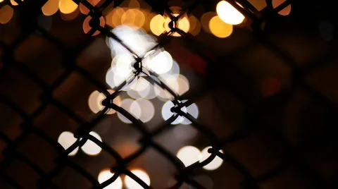 Night traffic through fence Stock Footage