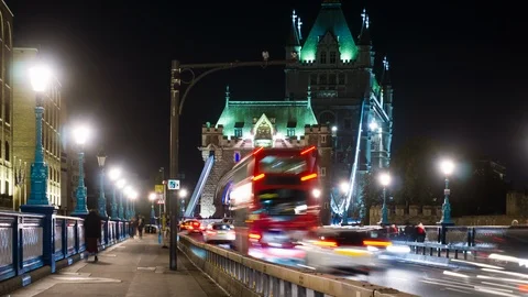 Night traffic through Tower bridge with moving red double-decker bus leaving 스톡 동영상 108010049