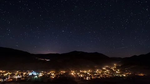 Night traffic in village and street lights under starry sky time lapse Stock Footage