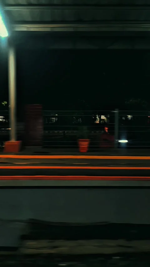 Night Train Departure: Motion Blur on an Indonesian Railway Platform Stock Footage 313399236