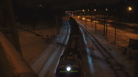 Night train goes under the bridge at winter. Stock Footage 82942516