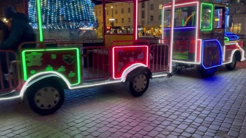Night train journey through lively city square, vibrant lights Stock Footage 281596006
