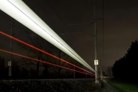 Night train light marks passing by. High speed long exposure Stock Photos