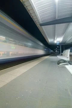 Night Train Passing Empty Platform at Urban Station With Motion Blur, Speed.. Stock Photos
