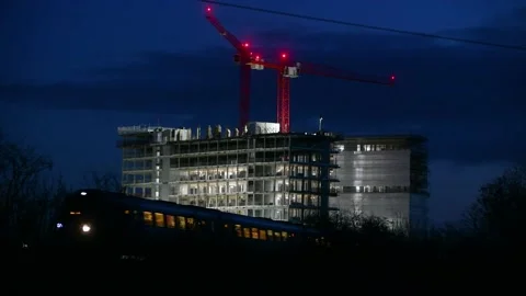 Night train running across front of construction site Stock Footage 143921383