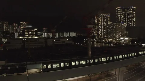 Night train shot from above, pulls up to the station. Tokyo night metro Stock Footage 108214156
